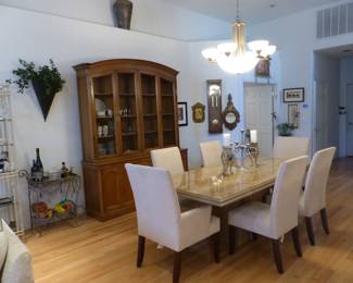 Travertine dining table with 6 neutral fabric chairs