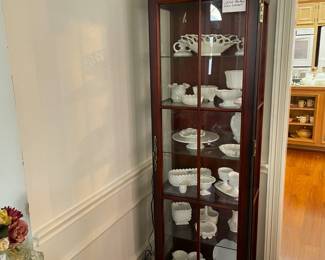 Lighted front opening curio cabinet.