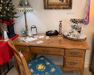 Desk and chair with needlepoint seat on chair.  Framed ornate fan.