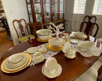 Dining table with eight side chairs and two leaves.