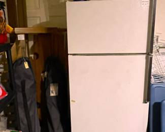 Kenmore refrigerator with icemaker.  Coleman ice chests, folding and bagged camping chairs, and a complete queen bed.