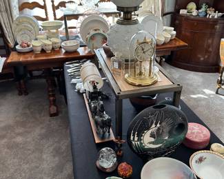 Another banquet table filled with treasures! At the center of the table, on the shelf A Large Fenton Cabbage Rose Lamp! 