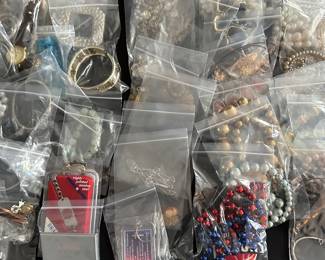 A banquet table filled with beautiful jewelry! Rings, Earrings, Bracelets, Brooches, Necklaces, Watches and MORE! Vintage to new! Sterling, Gold and precious stones! Also a large quantity of religious themed pieces! 