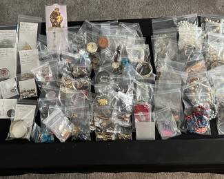 A banquet table filled with beautiful jewelry! Rings, Earrings, Bracelets, Brooches, Necklaces, Watches and MORE! Vintage to new! Sterling, Gold and precious stones! Also a large quantity of religious themed pieces! 