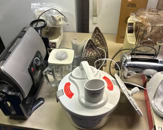 This is a table full of more small kitchen appliances! A pair of Rowenta Professional Steam Irons! 