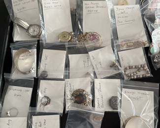 A banquet table filled with beautiful jewelry! Rings, Earrings, Bracelets, Brooches, Necklaces, Watches and MORE! Vintage to new! Sterling, Gold and precious stones! Also a large quantity of religious themed pieces! 