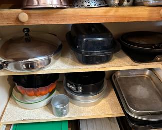 A large pantry stuffed with pots, pans, muffin tins etc...