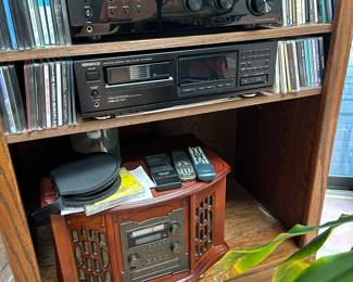 Top to bottom; Insigina, Kenwood and old timey record player, CD/ cassett/e AM FM stereo lower shelf, plus CDs to make you DANCE or Ponder!