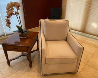 Beige/light tan occasional chair and side table with decor
