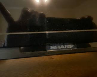 Sharp TV on armoire in master bedroom