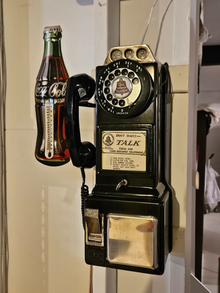 Vintage pay telephone, coke thermometer
