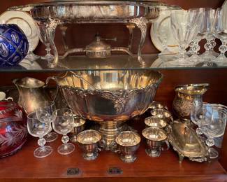 Silver punch bowl set, silver platters, misc silver serving pieces.