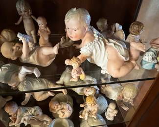Antique piano babies some appear to Conta Boehme bisque porcelain3”-18” in height, several are marked German, some mold numbers, many are unmarked.  All are very old.  There is only two or three Cupie babies. 
