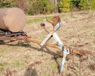 Trailer and 250 gallon drum, purchased by the homeowner to make a Pig Cooker. Drum is not mounted.