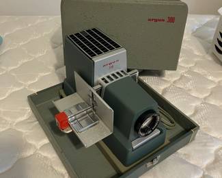 Vintage slide projector and scroll up screen