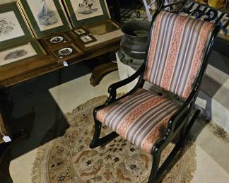 Framed art, upholstered rocking chair, area rug (items sold separately).