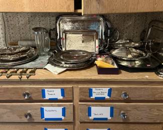 Silverplate with linens in drawers below