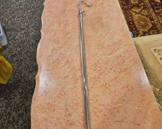 Long silver telescoping hook to reach items above head or clothing on high racks