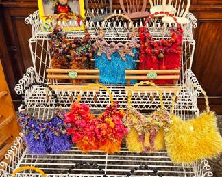 White plant stand and fun fuzzy purses in bright colors