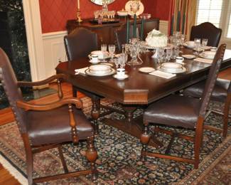 Outstanding North American Furniture Company (Canadian Co. 1910 - 1937) William & Mary Style Antique Mahogany Dining Table. The Set Includes  6 Leather Dining Chairs Accented with Brass Studded Detail, One of Which is a  Kings Chair.  (42" x 25"W x 20"D) Table is Shown with the Included Two 9.5" Leaves. Table Pads Included! 77 x 45"W x 30"H