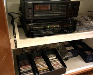 More of the audio system is showing here.  Several cassette tapes, a cassette player, and the tuner.