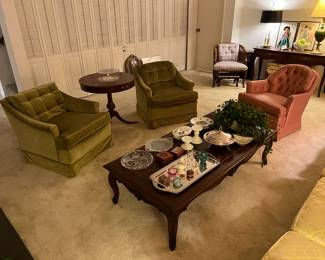 This is an overall picture of the living room, including the coffee table, a round side table, two matching overstuffed chairs, and more!