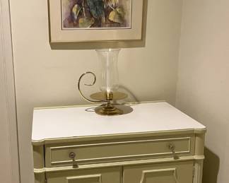 Don't forget about the framed artwork above this hallway cabinet and oil lamp.