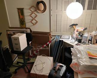 There are some art supplies mixed in with more desk items.  See the T-square just below the hanging orb of a lamp?  