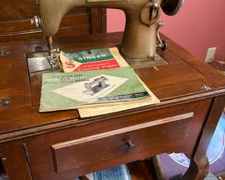 Antique Singer "New Home" sewing machine in cabinet
