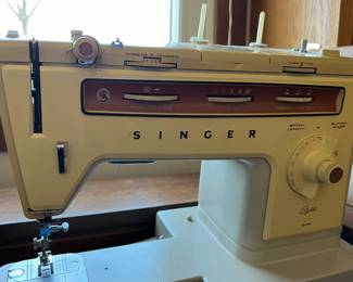 Vintage Singer Sewing machine in storage cabinet