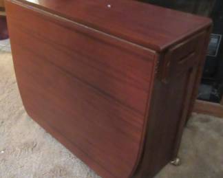 Super nice walnut drop leaf table with hidden drawers. Also has 4 hidden chair within the table bottom.  This is a very unusual table and super nice condition, it is very heavy.  Great for starter home or small kitchen or used as a game table.