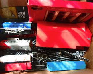 Box of misc. train parts, engines, track and cars. Sold by the box lot.