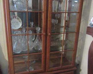 Nice two door display/china cabinet. Cut and pressed glass decanters.