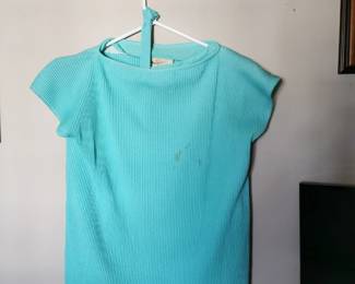 California West -Set aqua blue skirt and blouse set featuring short flutter sleeves, a matching belt, and a pleated skirt