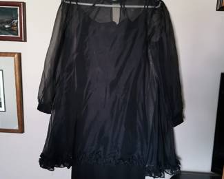 Vintage 1960s home-made sheer black a-line swing dress with cuffed bishop sleeves and a ruffled bottom, including a black slip dress to wear underneath