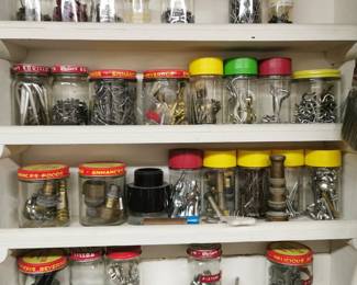 A small workroom featuring various hardware and screws