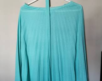 Skirt detail of California West -Set aqua blue skirt and blouse set featuring short flutter sleeves, a matching belt, and a pleated skirt