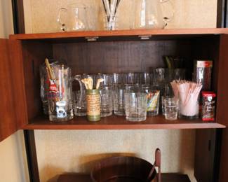 Vintage barware including pitchers, glasses, and swizzle sticks
