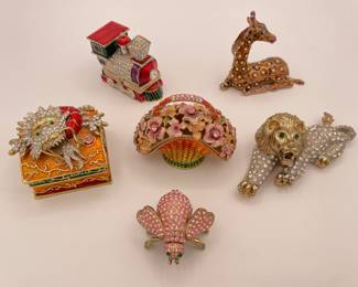 A small collection of enamel and rhinestone trinket boxes, featuring a Chinese dragon, a train, a giraffe, a lion, a fly, and a flower basket