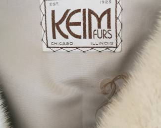 Tag detail of vintage oversized sand colored fur jacket featuring wide sleeves and a zip closure by Keim Furs Chicago Illinois