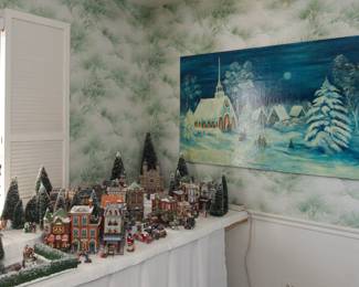 A very tiny part of the Department 56 Christmas Village collection and a hand painted oil on canvas winter church scene