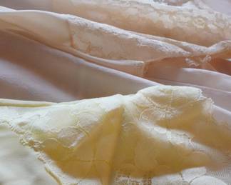 Detail of Wonder Maid vintage lace and satin camisoles or slips in nude and yellow