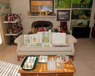 Chippendale style sofa, Pennsylvania House oak coffee table, Pimpernel placemats and coasters, Made in England, and multiple pieces of original art