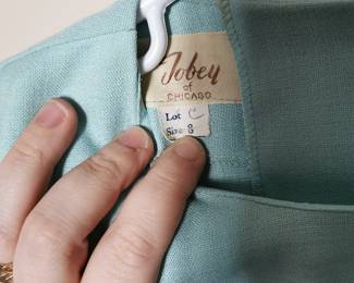 Tag detail of lovely vintage 1960s or 1970s Tobey of Chicago aqua blue mini skirt and blouse set, featuring a red embroidered flower, Size 8