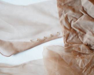 Detail on the three vintage nylon hose with seams with rhinestones on the back of the ankles......
