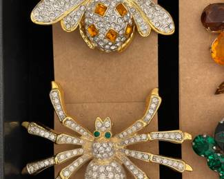 Detail of whimsical pins/brooches featuring a ladybug and a spider
