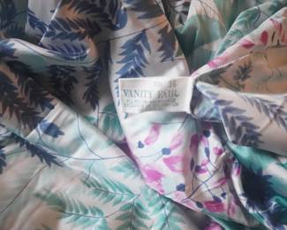 Tag detail of satin Vanity Fair vintage nightgown with a deep v-neckline and short sleeves, Size 36