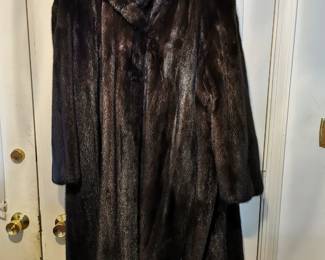 Long luxurious vintage fur coat in a deep rich brown, featuring wide sleeves, a dramatic collar, and frog closures by Keim Furs Chicago Illinois