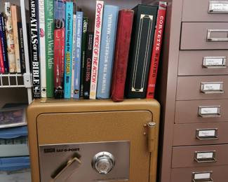 Oversized or Coffee Table books featured on top of a SAGA Saf-O-Posit combination lock safe