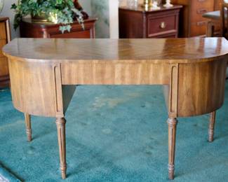 Lovely desk or dressing table that can be free-standing as it is finished on all sides, with the back elegantly curved in a demilune form.